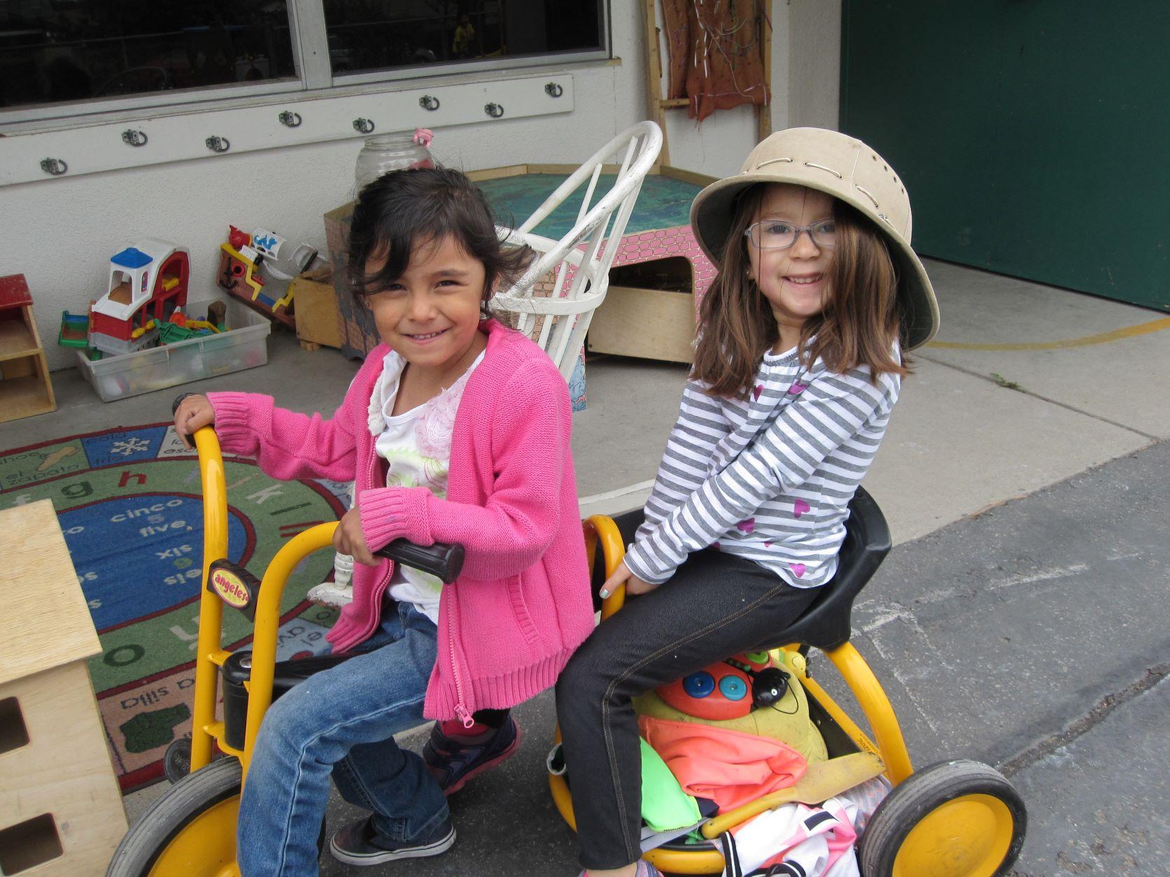 two children on tricycle